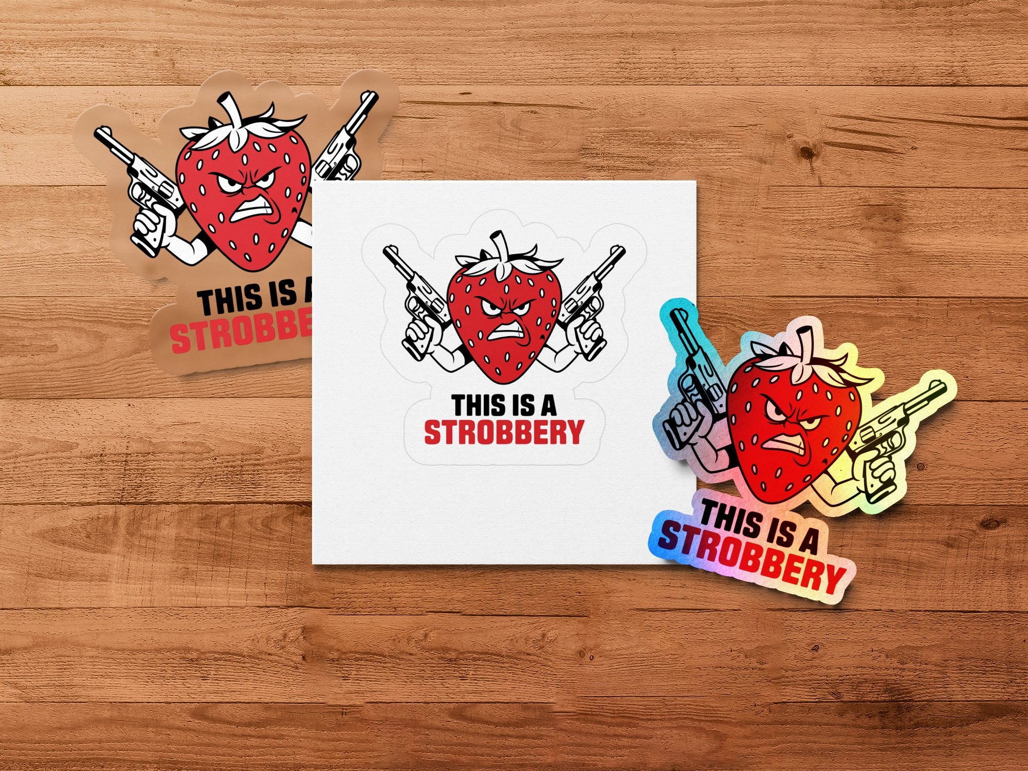 Two stickers of a cartoon strawberry with guns, saying "THIS IS A STROBBERY".