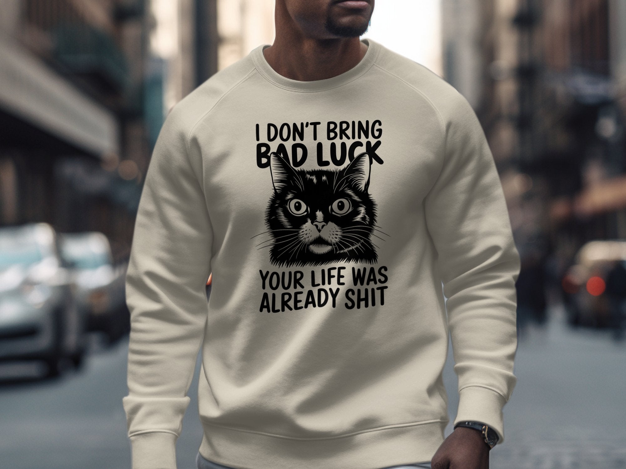 Cream sweatshirt with a black cat illustration and humorous text.