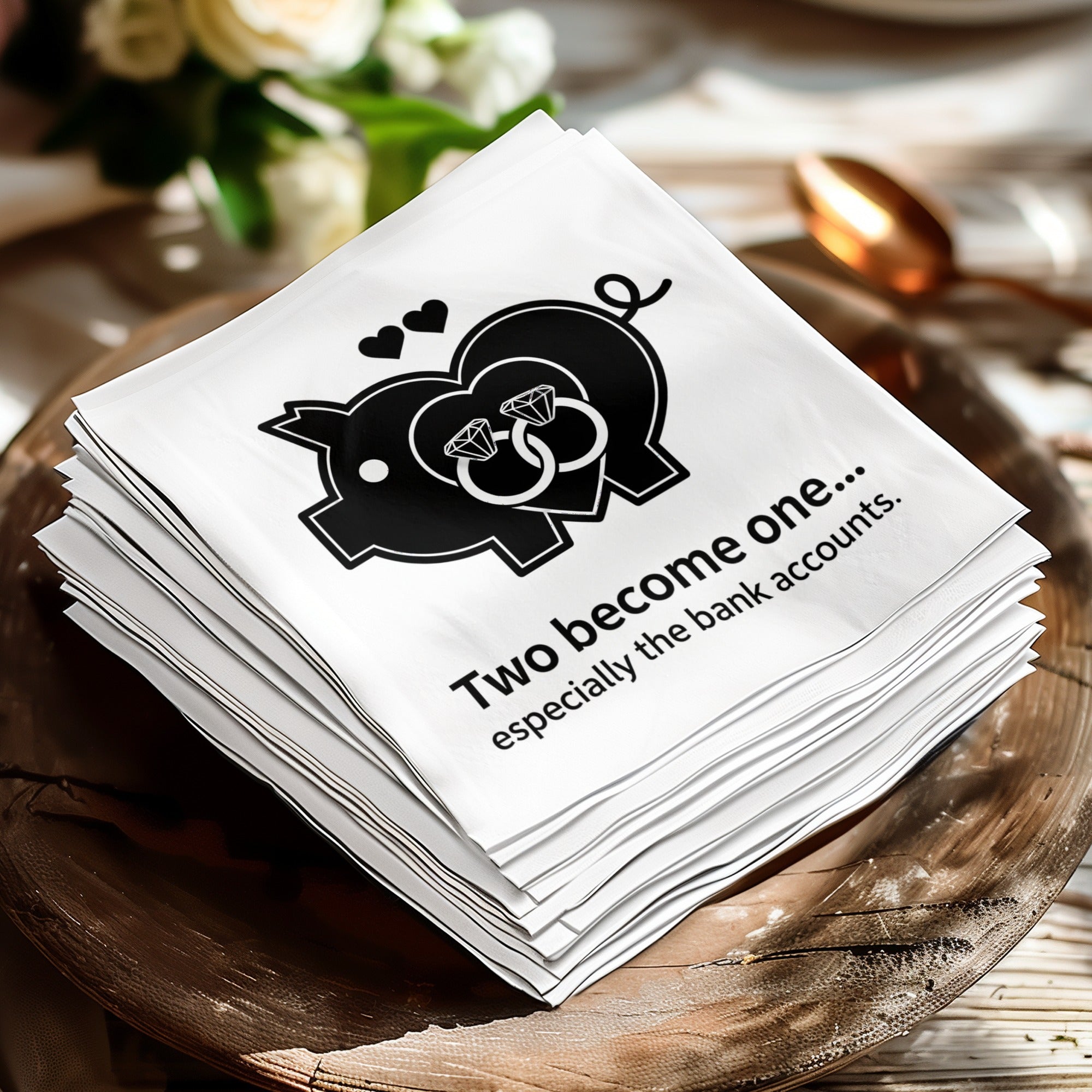 White napkin with pig illustration, wedding rings, and text "Two become one.. especially the bank accounts..".