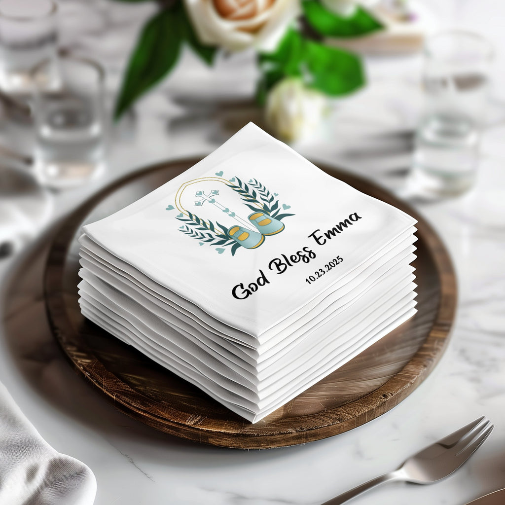 Stack of white napkins with "God Bless Emma" and a cross design.