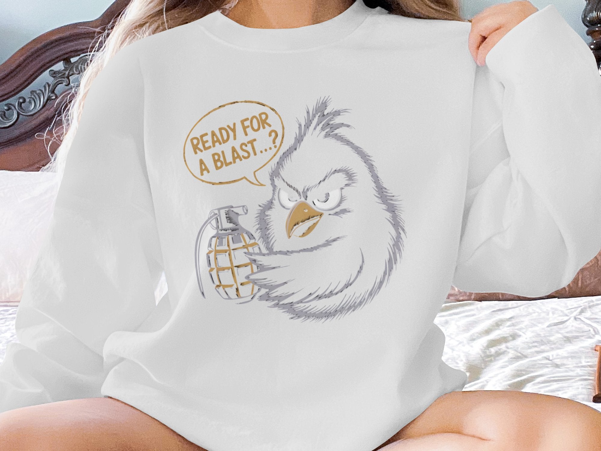White sweatshirt with angry cartoon bird holding a grenade, text "READY FOR A BLAST...?".