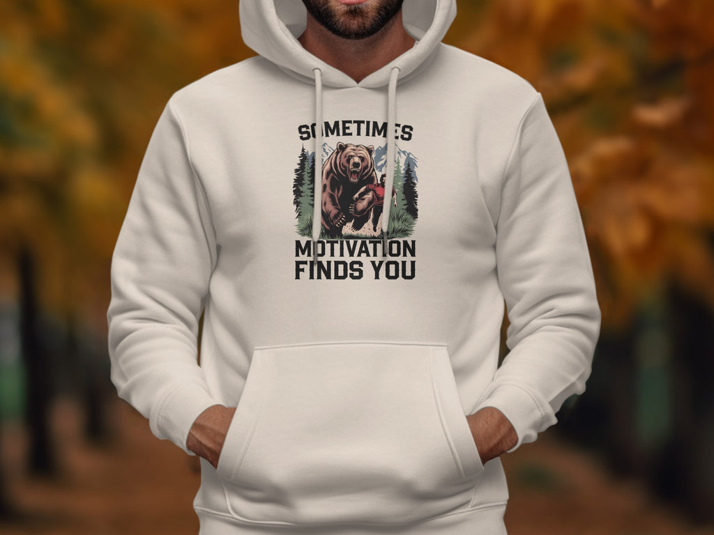 White hoodie with bear graphic and text "Sometimes motivation finds you".