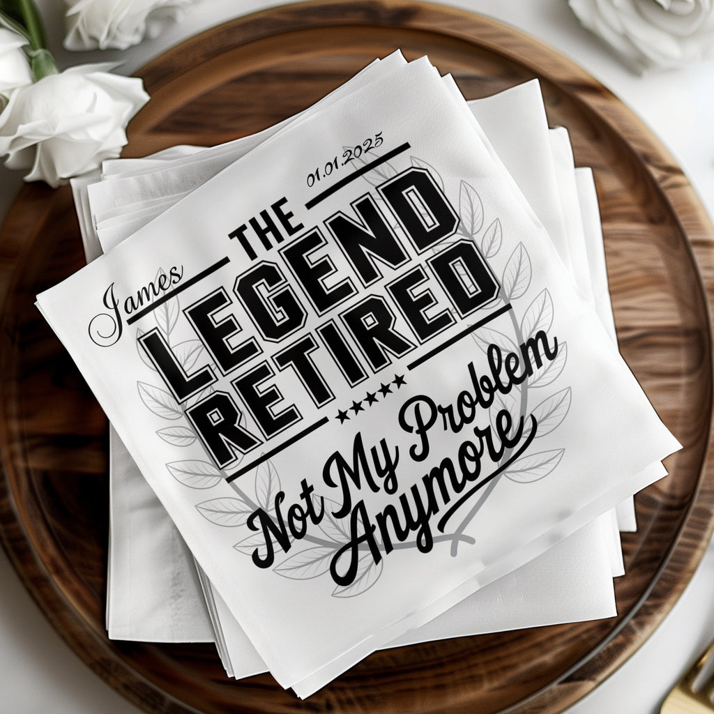 White napkins with "The Legend Retired" design, personalized with "James" and "01.01.2025".