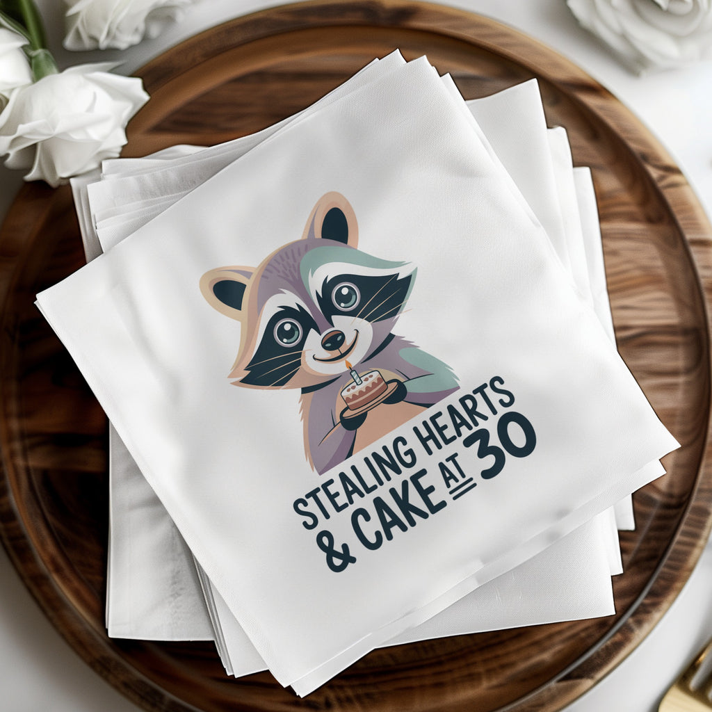 Napkins with a raccoon holding a birthday cake and text "Stealing hearts & cake at 30".