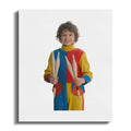 Smiling boy in colorful jumpsuit holds juggling pins.