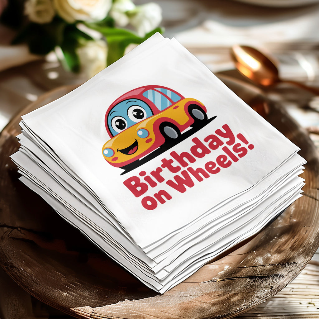Stack of white napkins featuring a cartoon car with "Birthday on Wheels!" text.