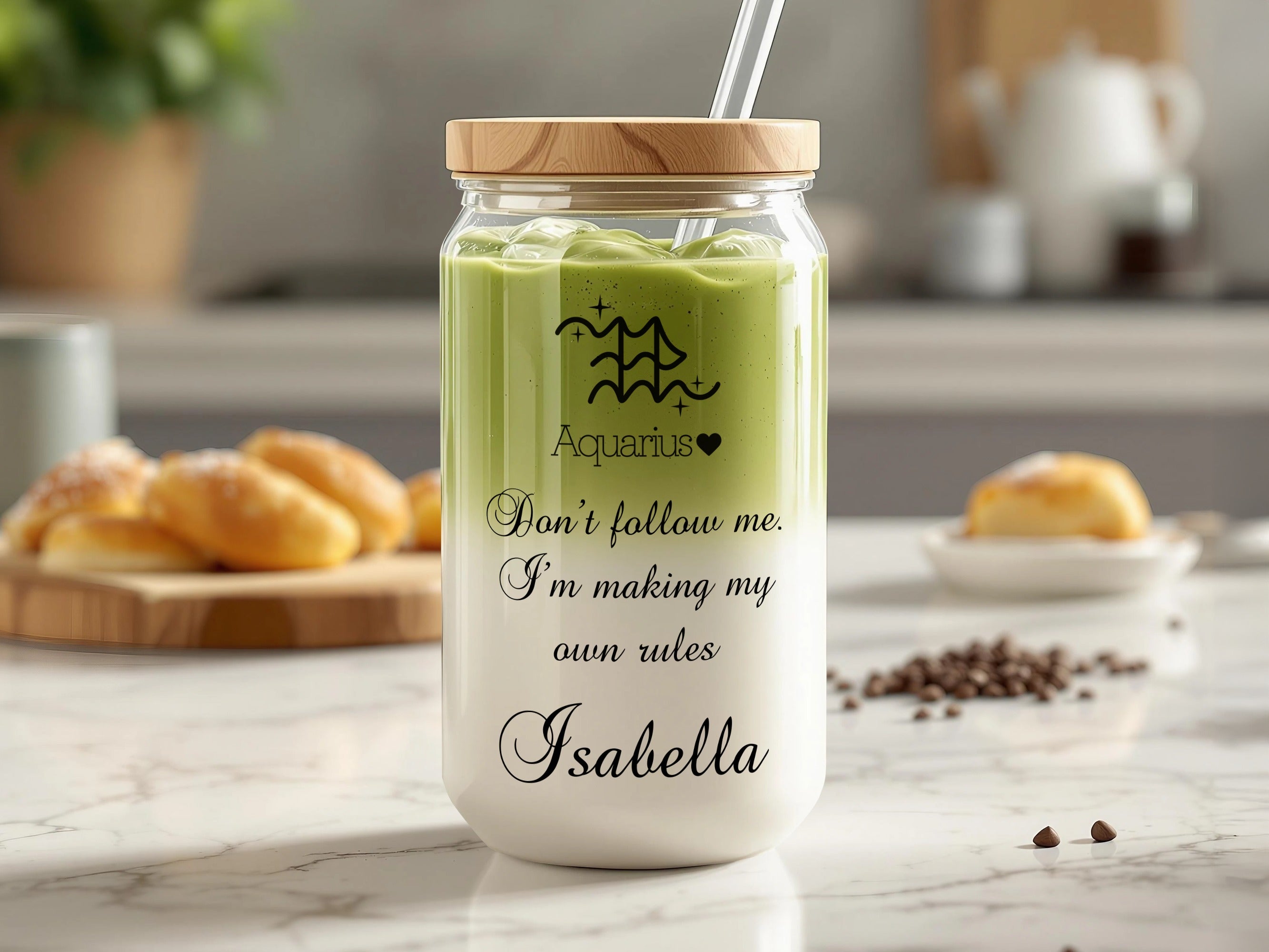 Glass tumbler with a straw, featuring "Aquarius" and "Isabella" in decorative script.
