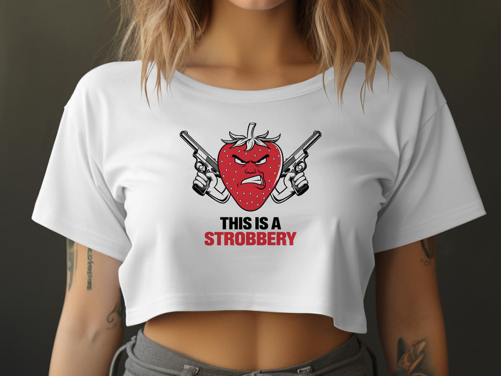 White crop top with "THIS IS A STROBBERY" text and crossed guns behind a strawberry.