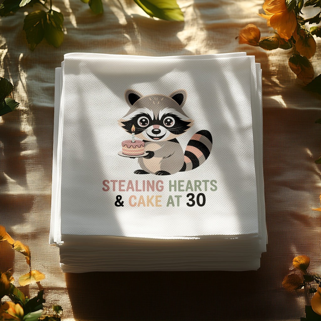 Napkins with a raccoon holding a cake and text "Stealing Hearts & Cake at 30".