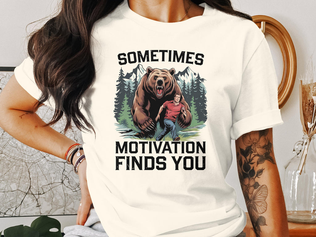 Man running from a bear in a forest with text "SOMETIMES MOTIVATION FINDS YOU".
