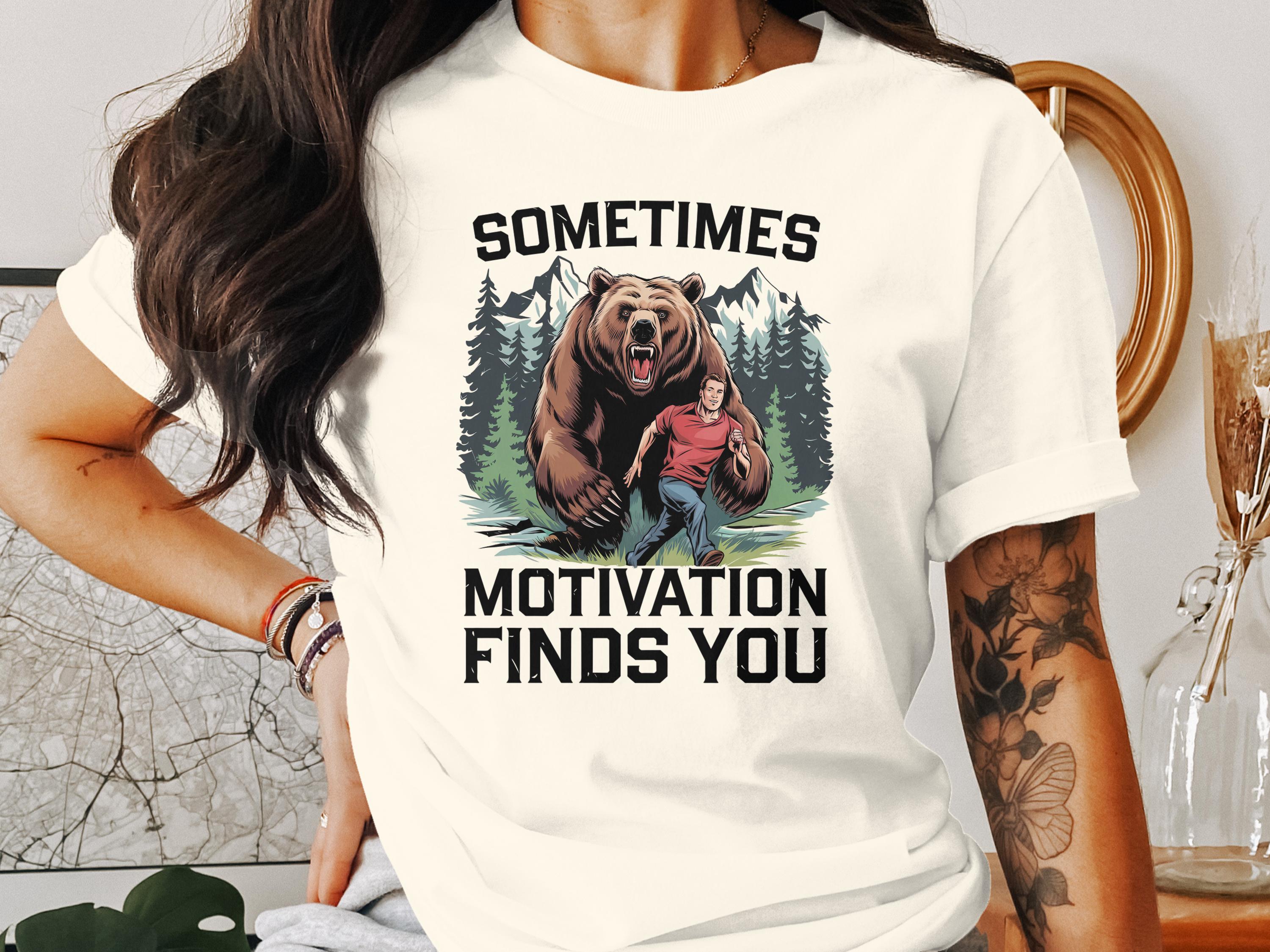 Man running from a bear in a forest with text "SOMETIMES MOTIVATION FINDS YOU".