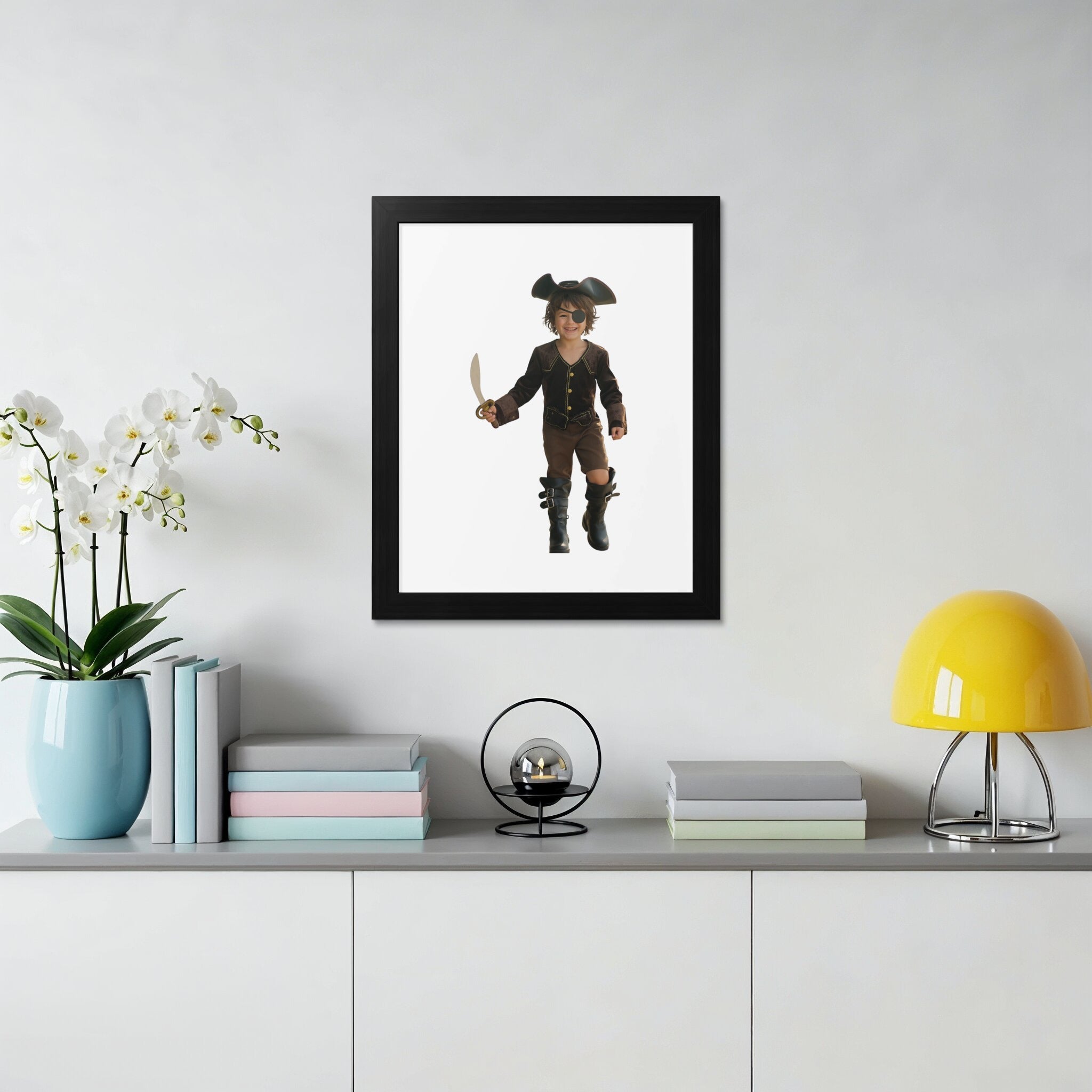 Child dressed as a pirate with sword and hat in framed portrait.