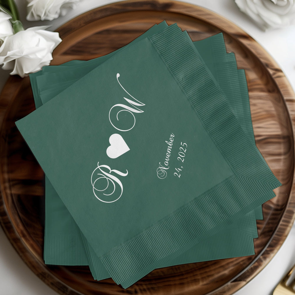 Green cocktail napkins with white "R W" monogram and November 24, 2025 date.