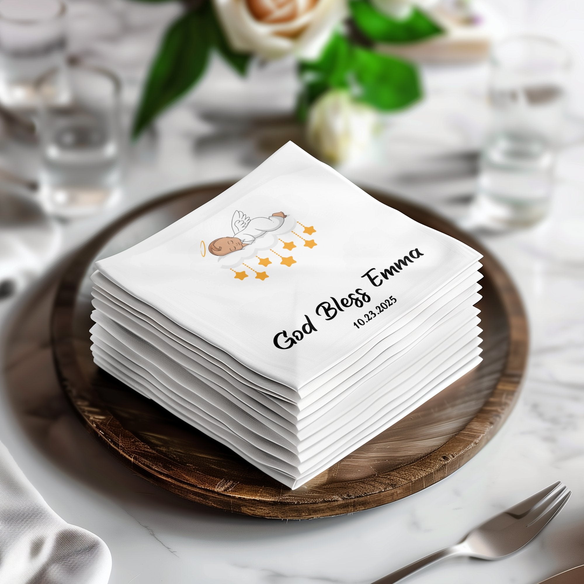 Stack of white napkins with "God Bless Emma 10.23.2025" and cloud design.