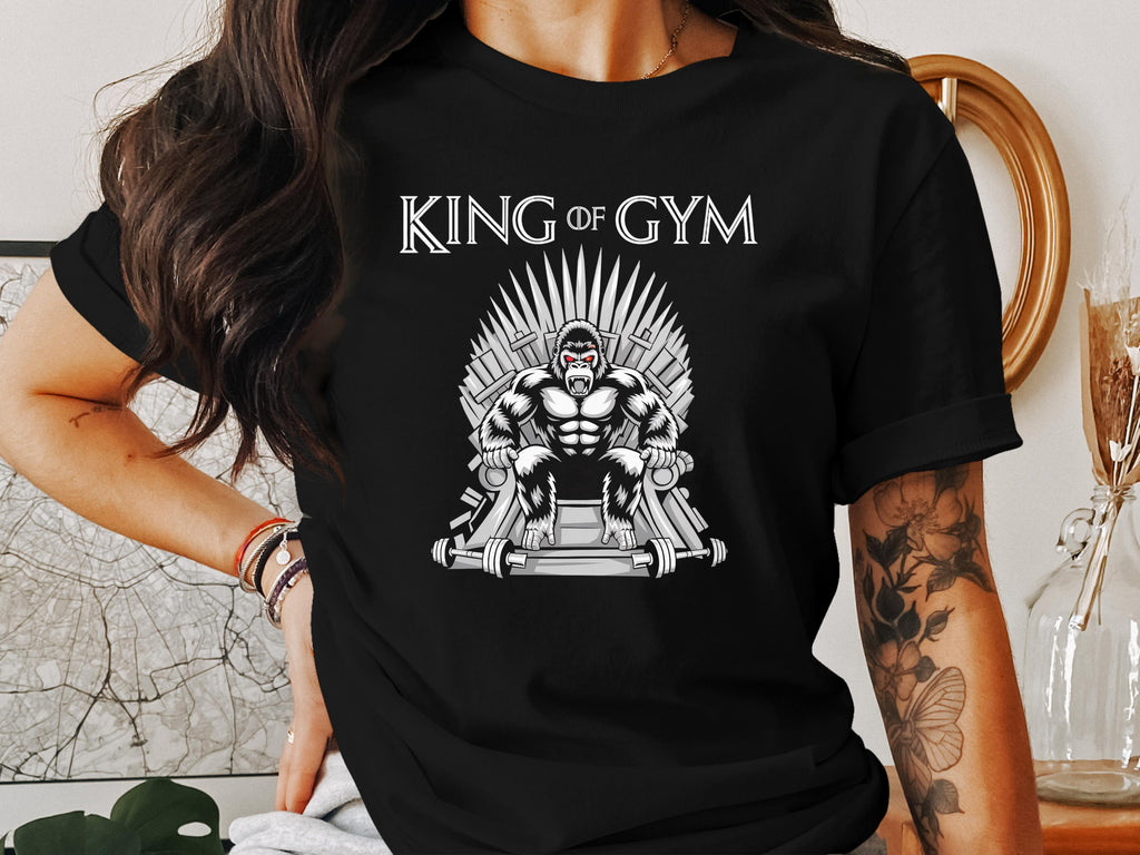 Gorilla on a throne made of gym equipment, text reads "King of Gym".
