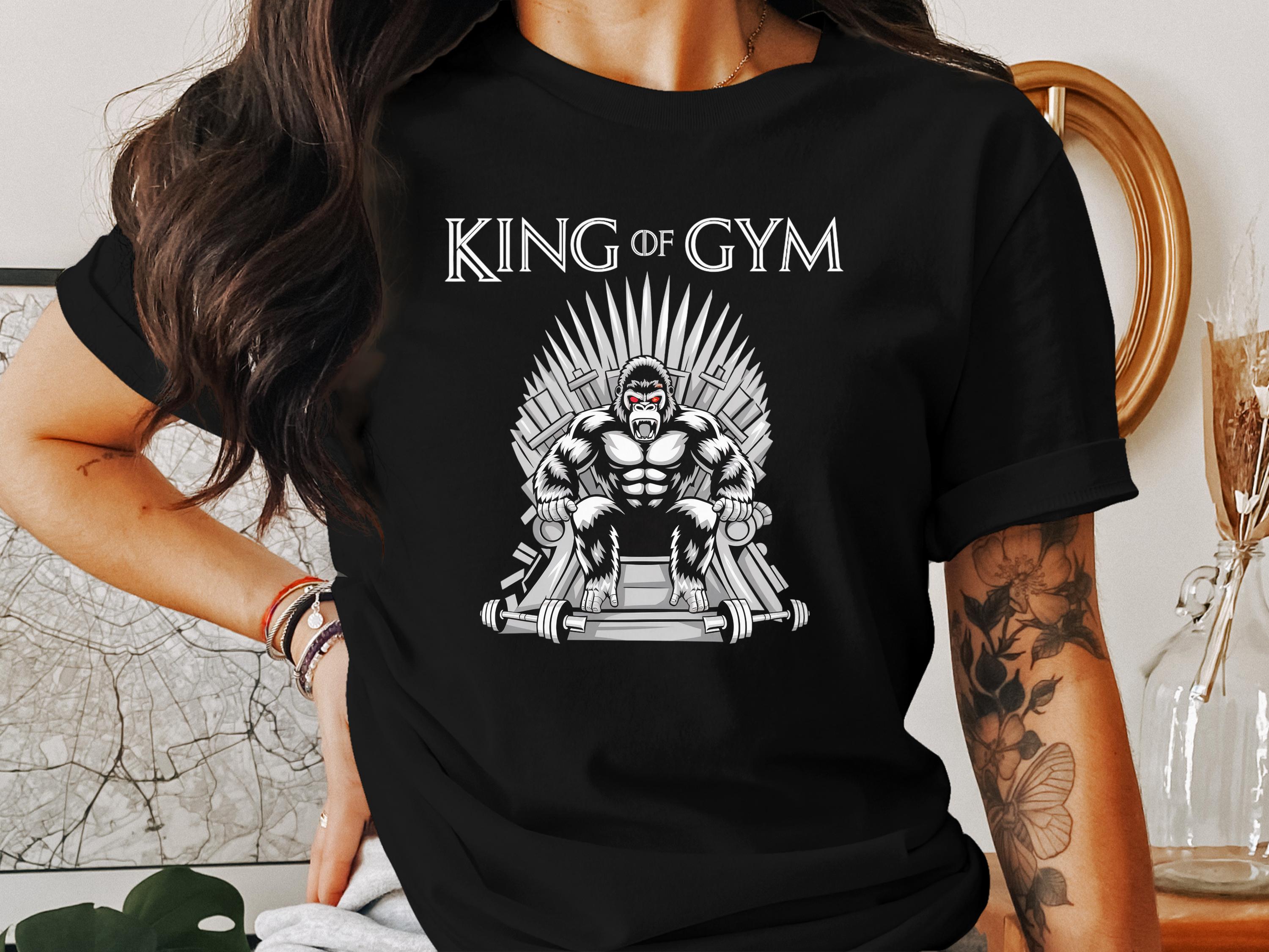 Gorilla on a throne made of gym equipment, text reads "King of Gym".