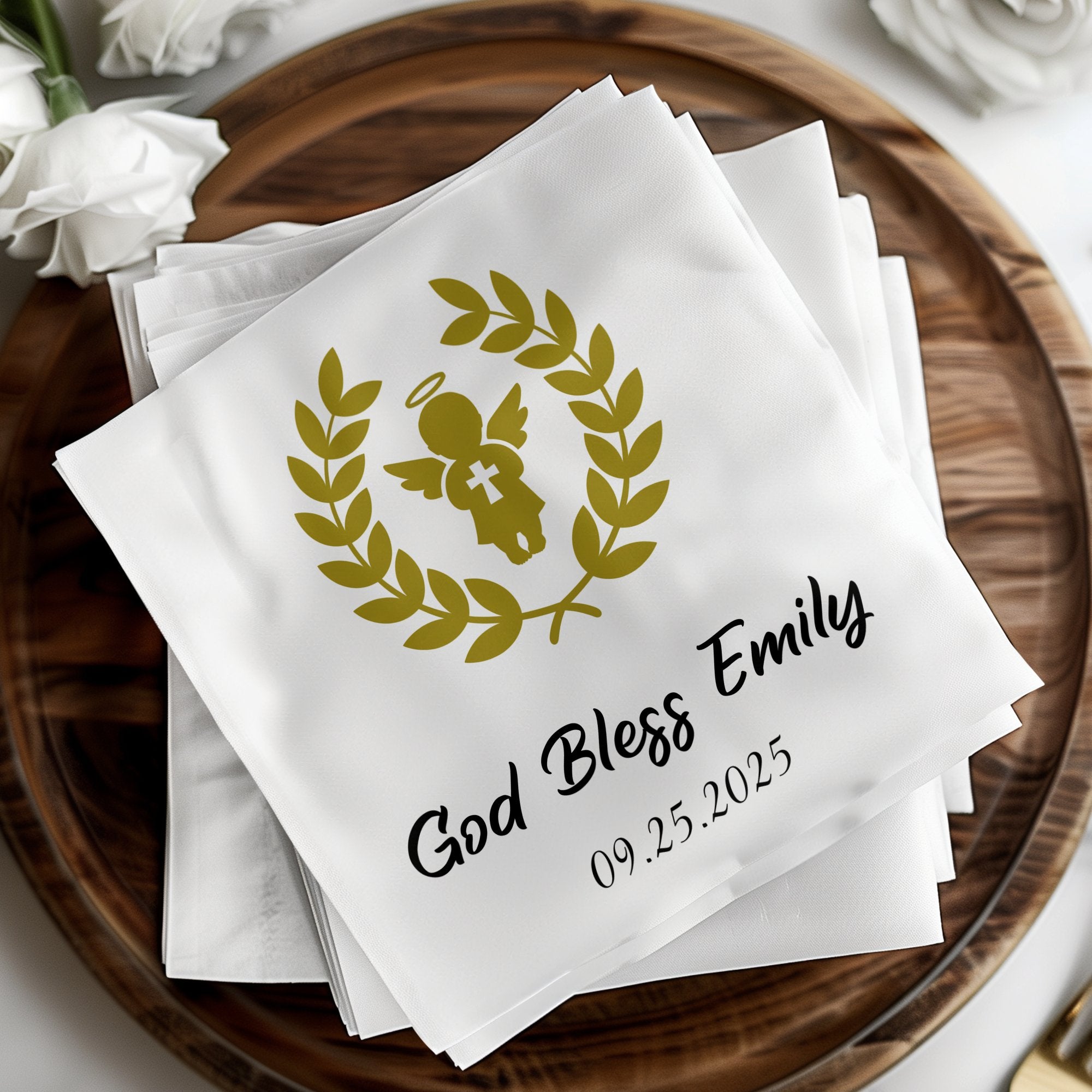 White napkins with "God Bless Emily 09.25.2025" and a golden angel emblem.