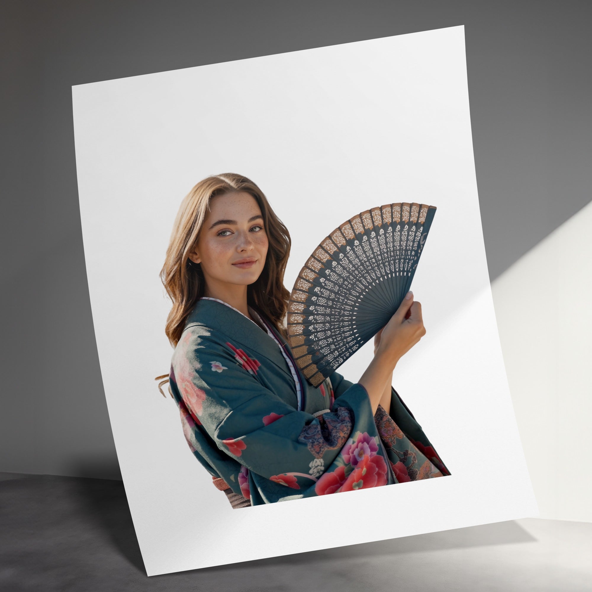 Woman in a green kimono holding an ornate black fan.