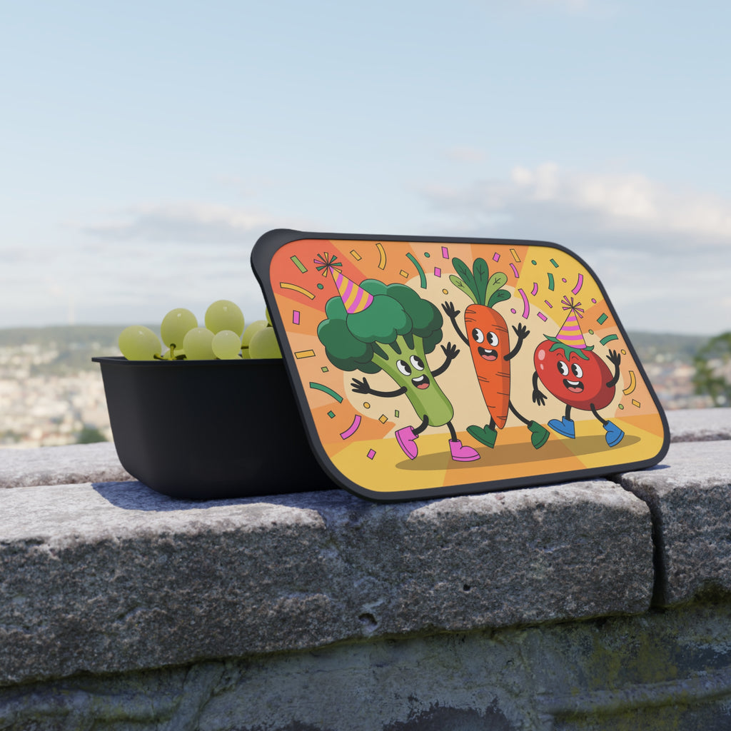 Lunchbox lid with cartoon broccoli, carrot, and tomato celebrating with party hats.