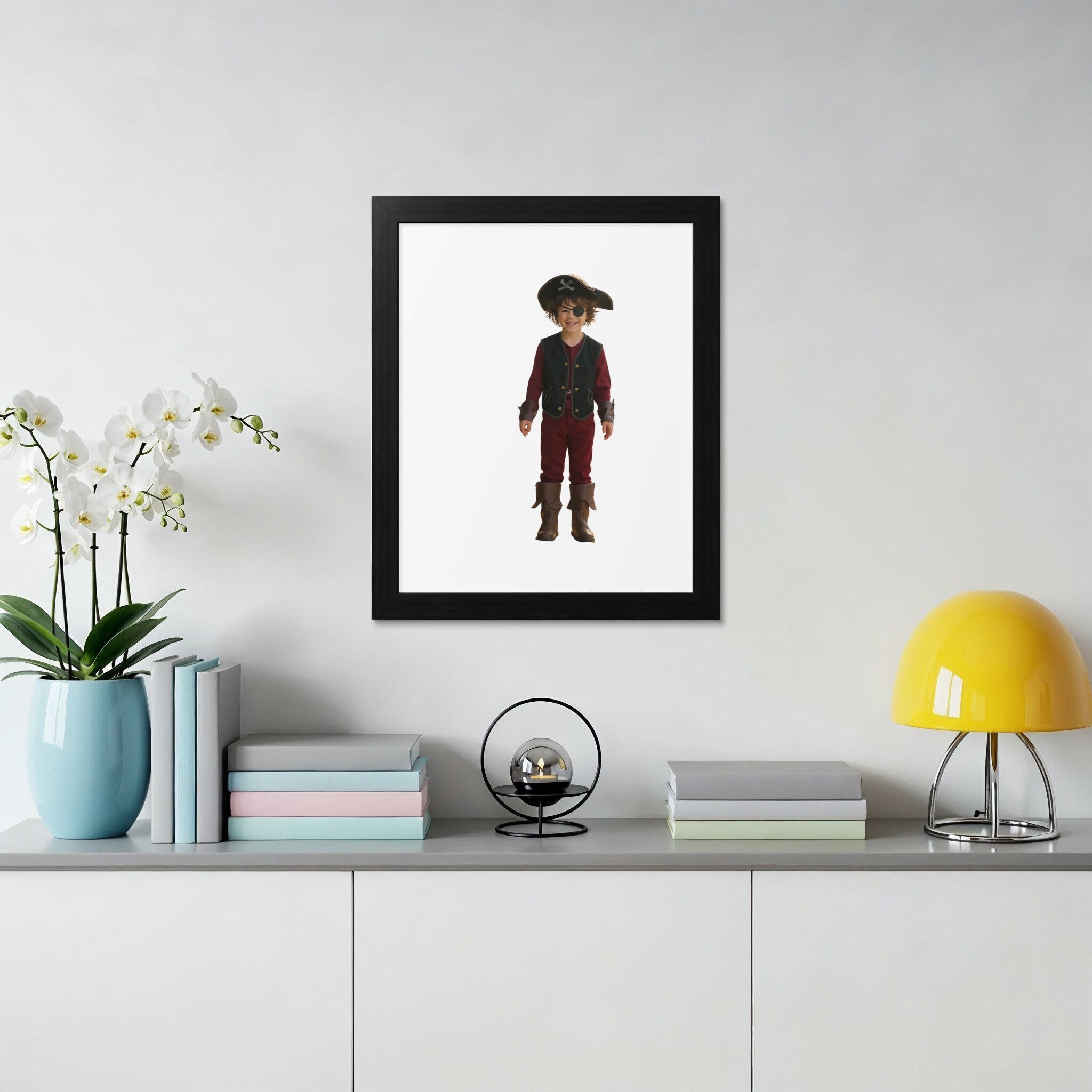 Child in pirate costume with hat and boots in framed portrait.