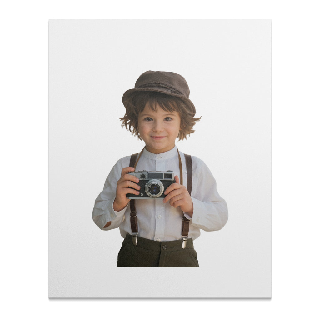 Young boy in hat and suspenders holding a vintage camera.
