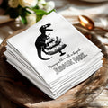 Napkin with dinosaur carrying cake and "Marriage is like a walk in the park... Jurassic Park" text.
