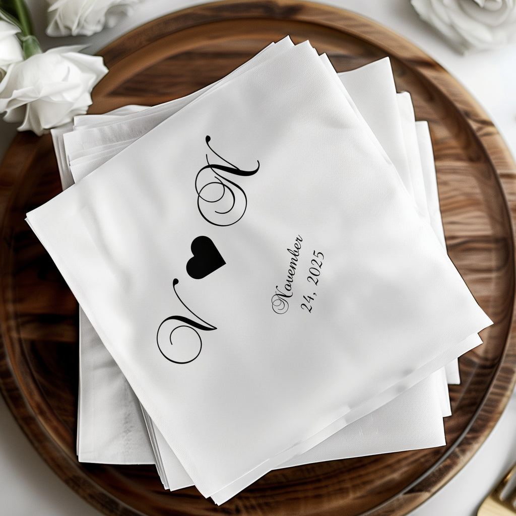 White cocktail napkins with black monogram "N" and "V" and "November 24, 2025".