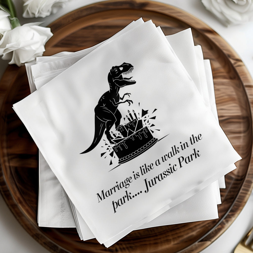 Wedding napkins with T-Rex on cake and text "Marriage is like a walk in the park.... Jurassic Park."