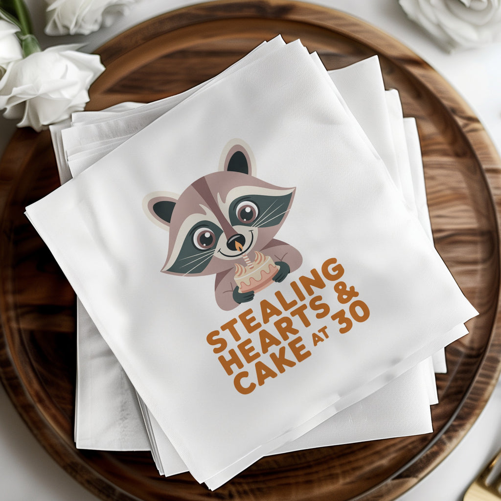 Napkins with raccoon holding cake and text "Stealing Hearts & Cake at 30".
