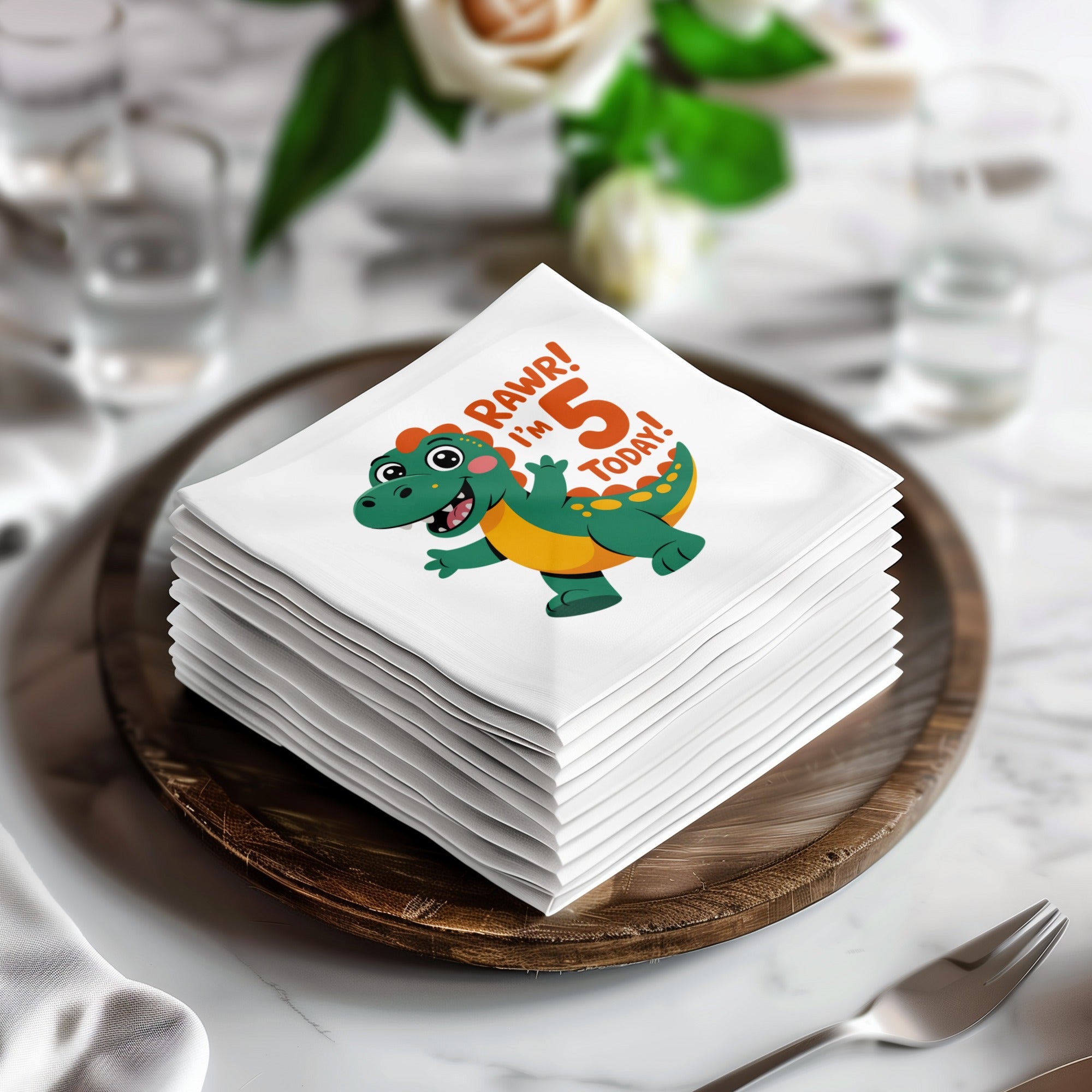 Stack of white napkins with a cartoon dinosaur saying "Rawr! I'm 5 Today!".