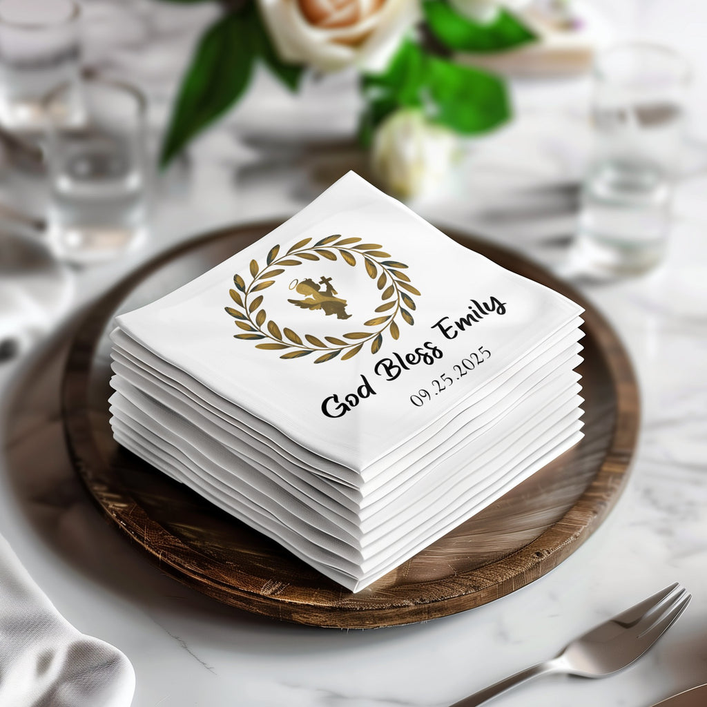 White cocktail napkins stacked, featuring "God Bless Emily" and "09.25.2025" with a laurel wreath.