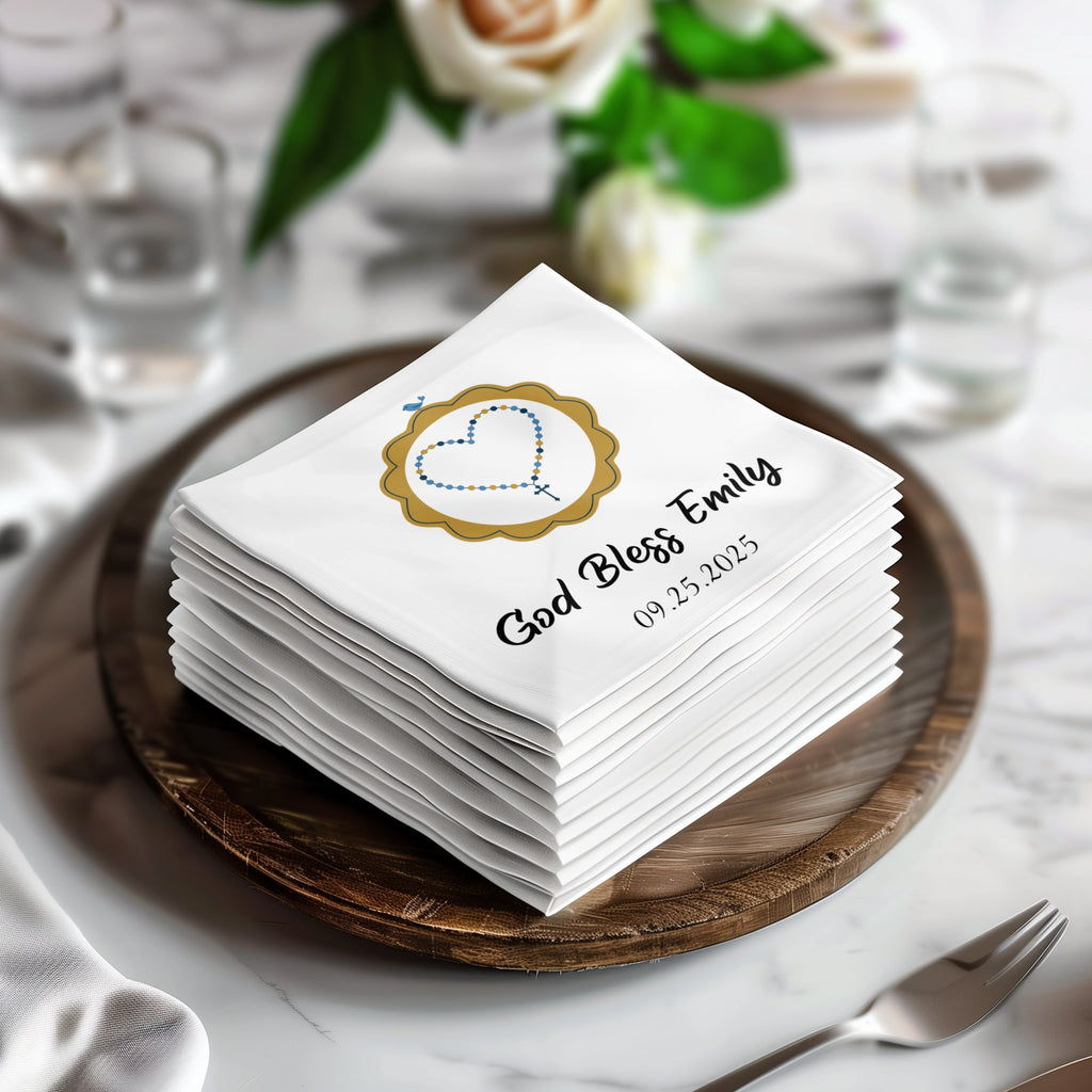 Stack of white napkins personalized with "God Bless Emily" and date.