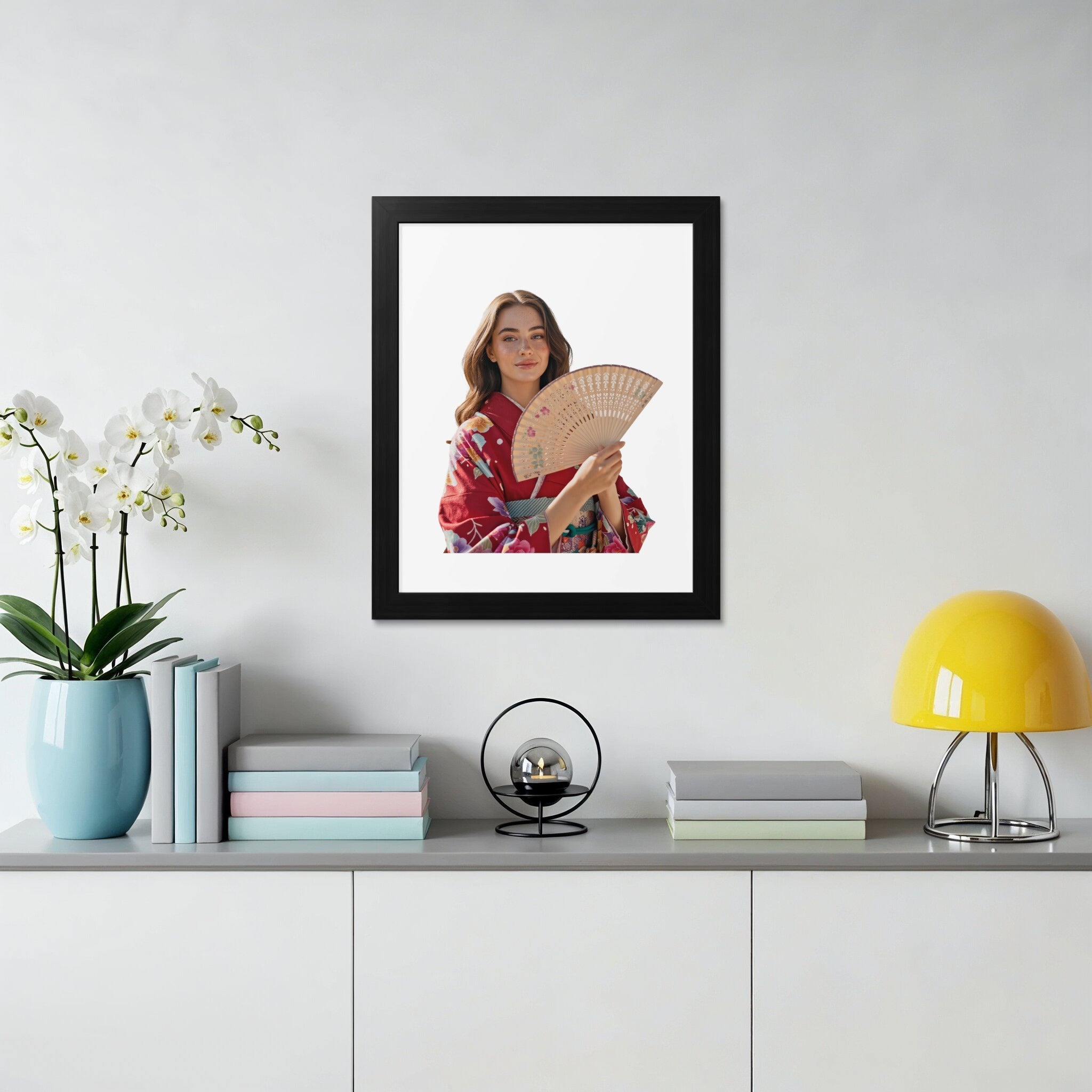 Woman in red kimono holding a fan, framed on a shelf.