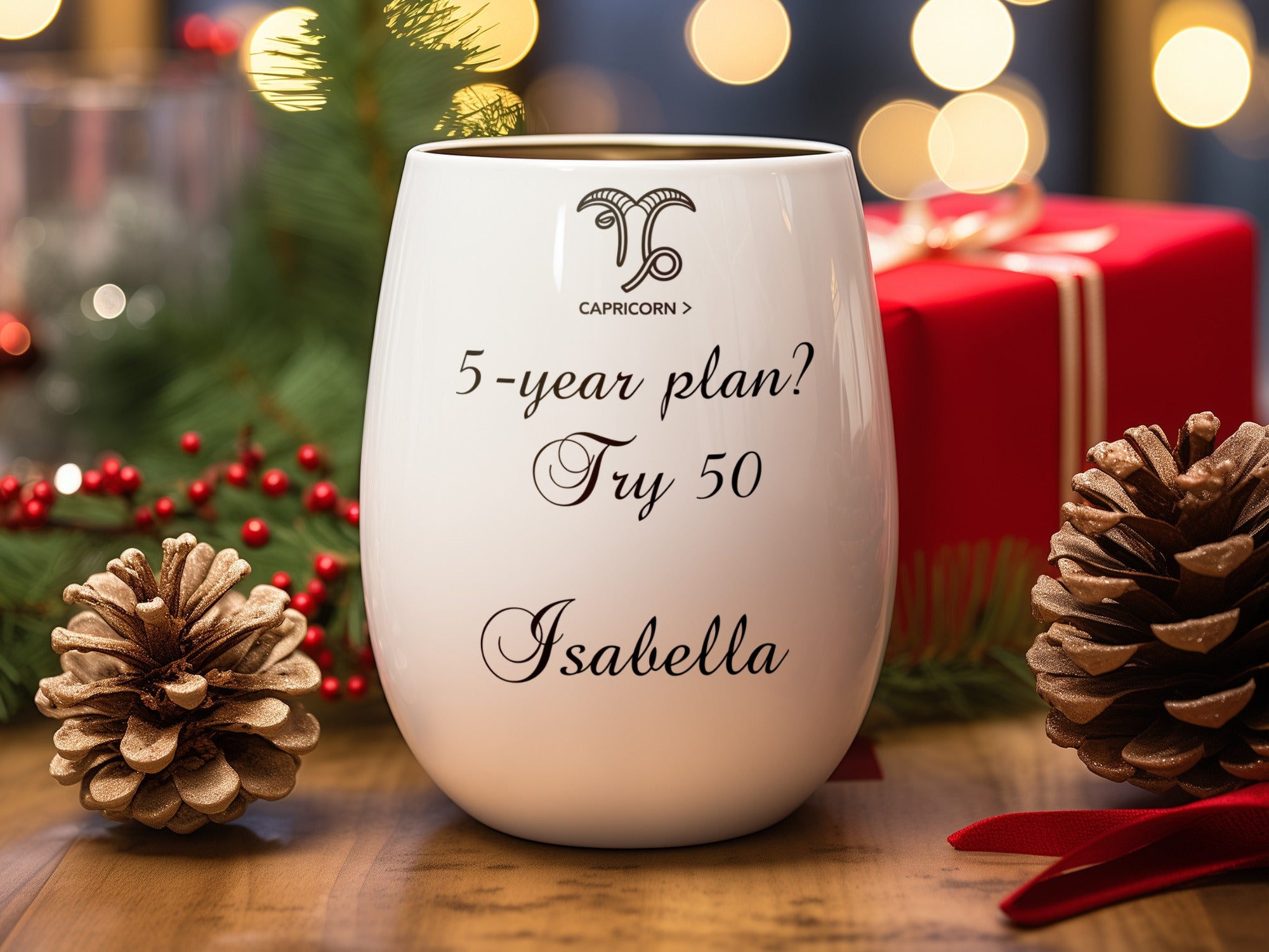 White wine glass with "Capricorn 5-year plan? Try 50 Isabella" text, festive holiday background.