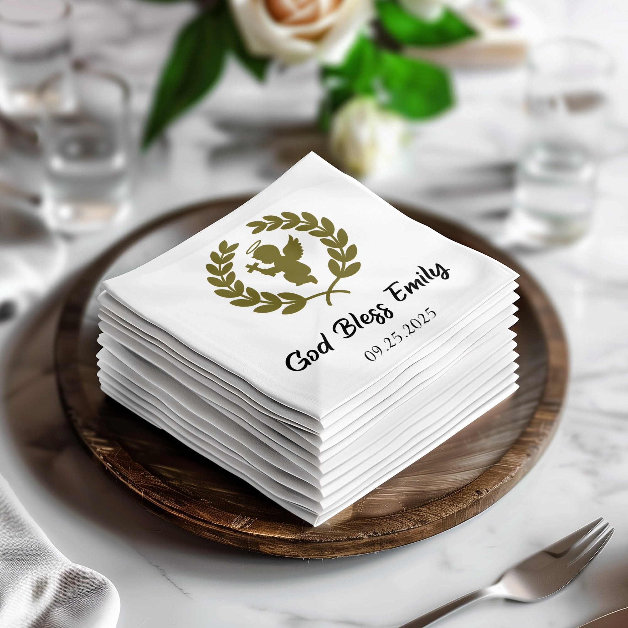 Stack of white napkins with "God Bless Emily 09.25.2025" and an angel graphic.