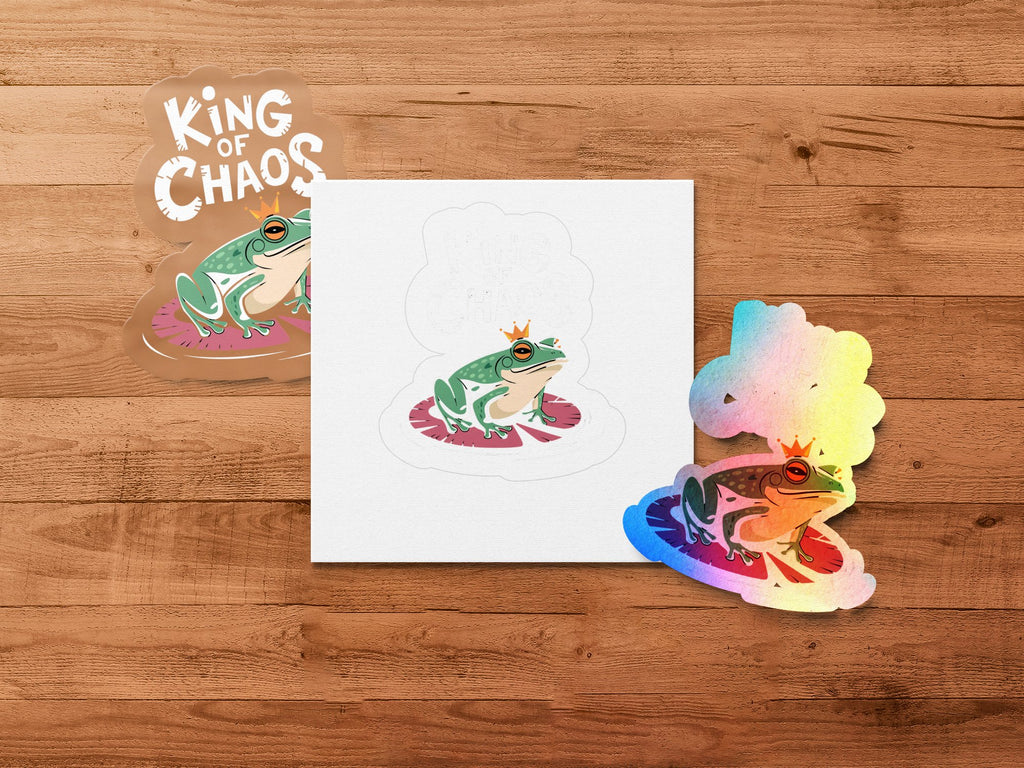 Three stylized frogs with crowns, two on lily pads, with "King of Chaos" text.