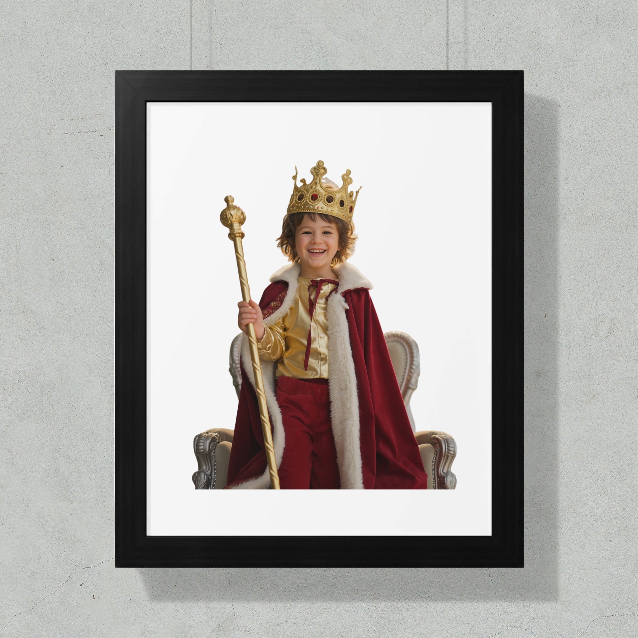 Smiling child in king costume with crown and scepter, seated on ornate throne.
