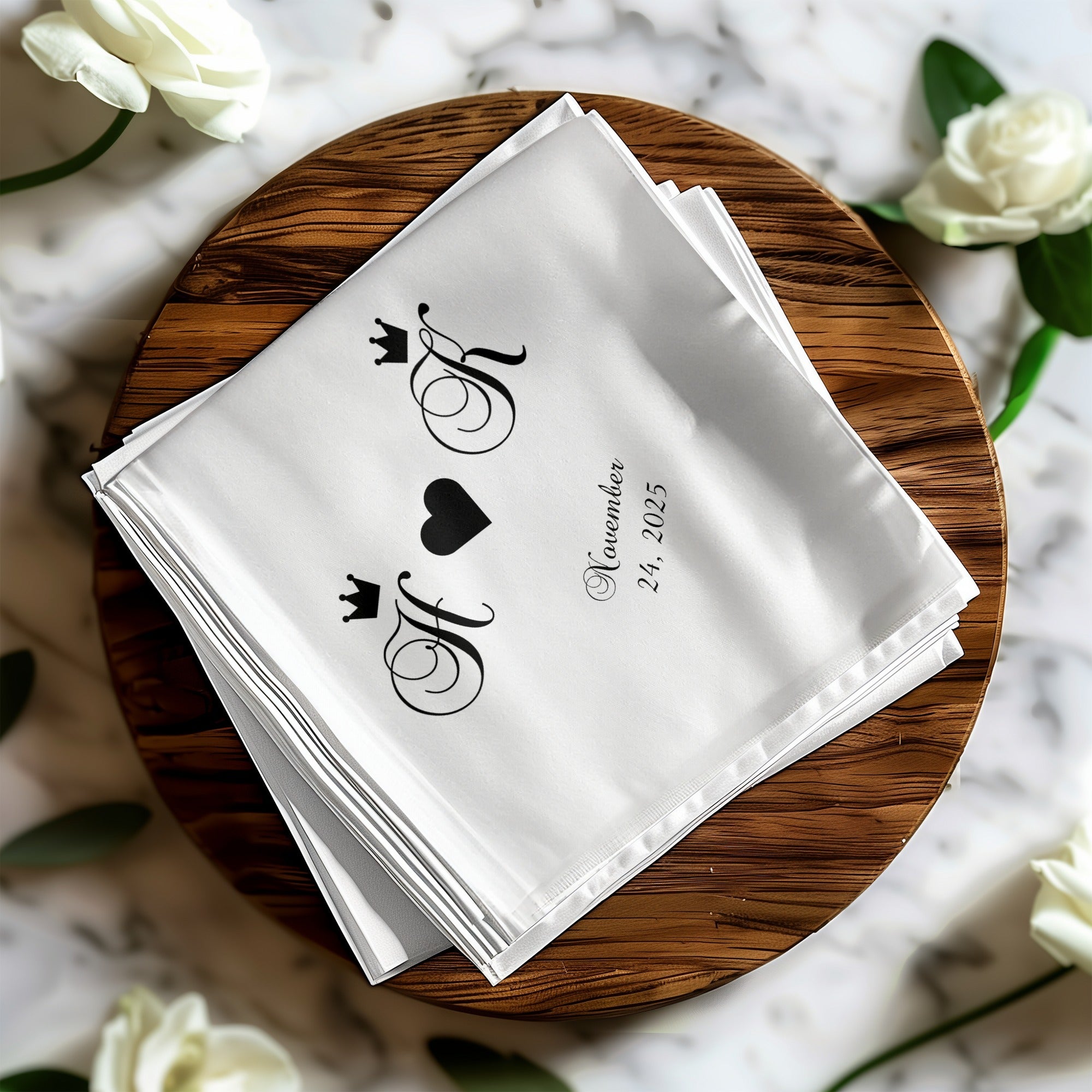 White linen napkins with black monograms and "November 24, 2025" text.