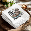 Napkins with a cartoon otter and text "Just Otter Here Surviving 30".