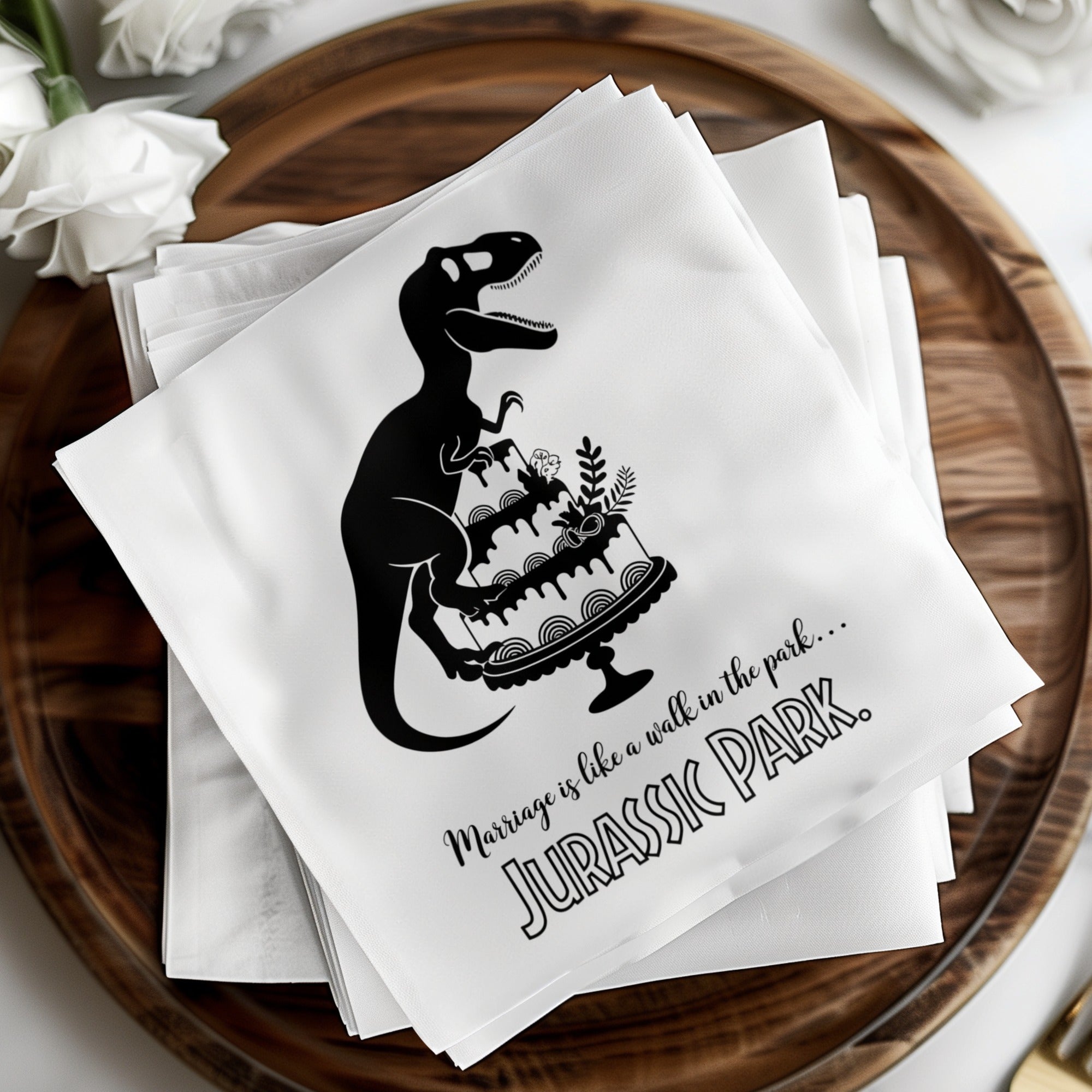 Dinosaur carrying Jurassic Park cake on stack of napkins.