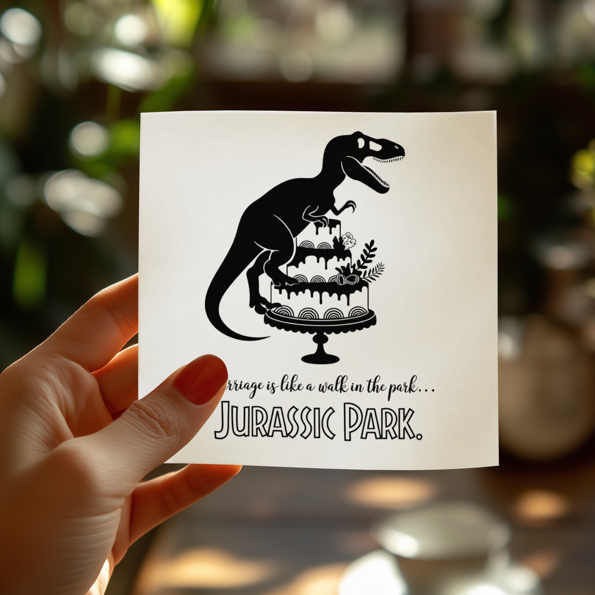 Silhouette of T-Rex on a cake with text "Marriage is like a walk in the park... Jurassic Park."