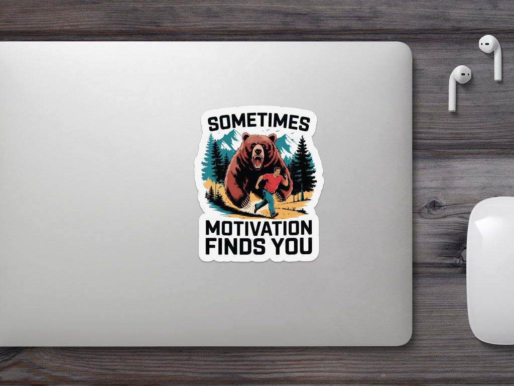 Sticker: Man running from a bear with text "SOMETIMES MOTIVATION FINDS YOU".
