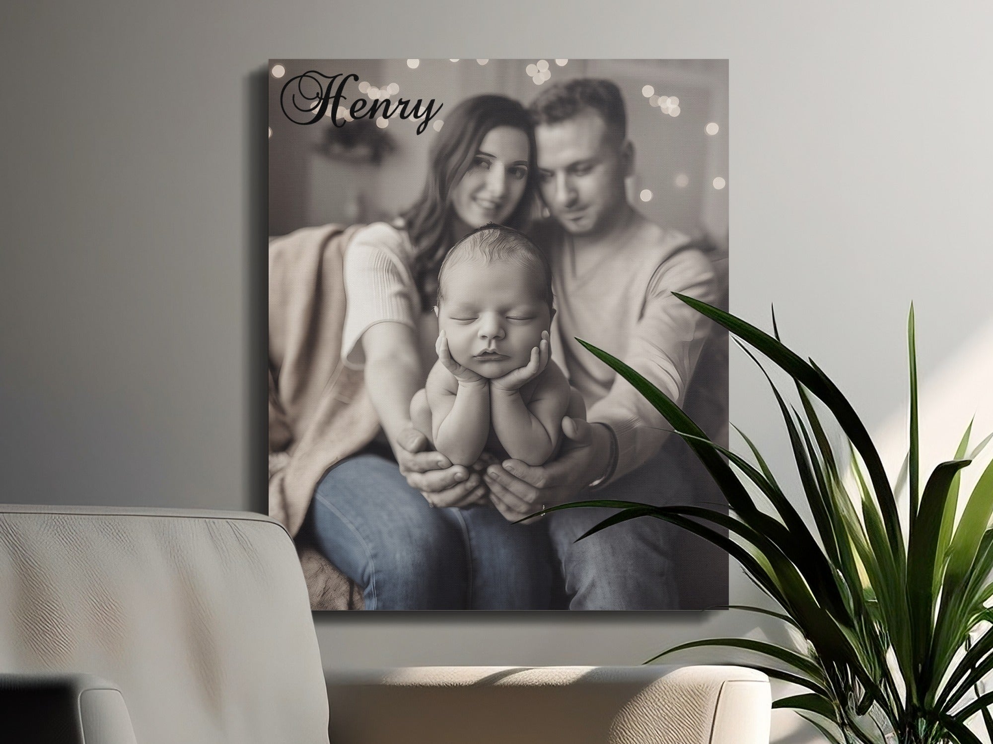 "Henry" text over newborn baby held by parents, grayscale, soft focus.