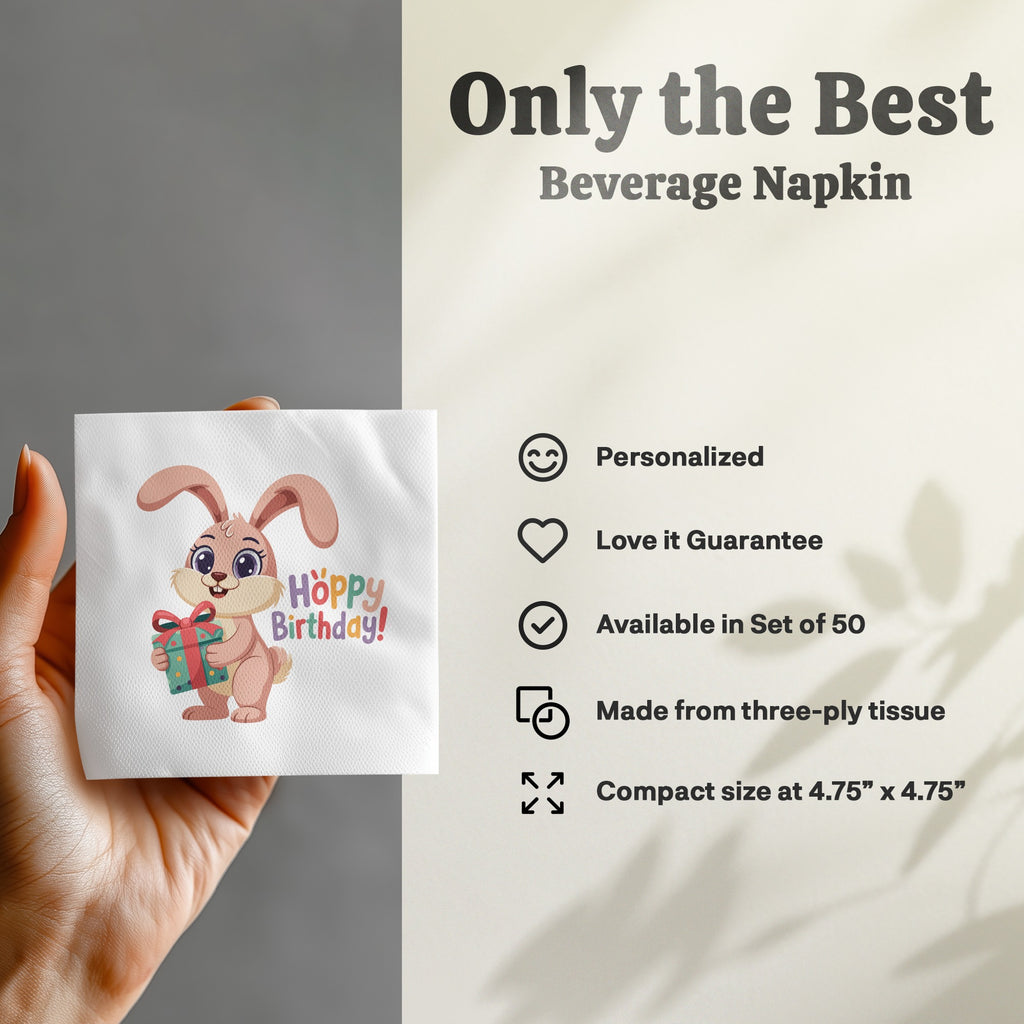Beverage napkin with a cartoon bunny holding a gift, "Hoppy Birthday!" text.