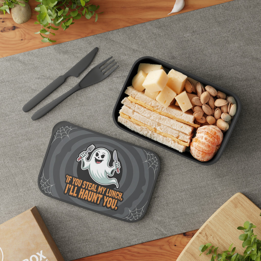 Halloween lunchbox with ghost graphic and text, filled with sandwich, cheese, and nuts.