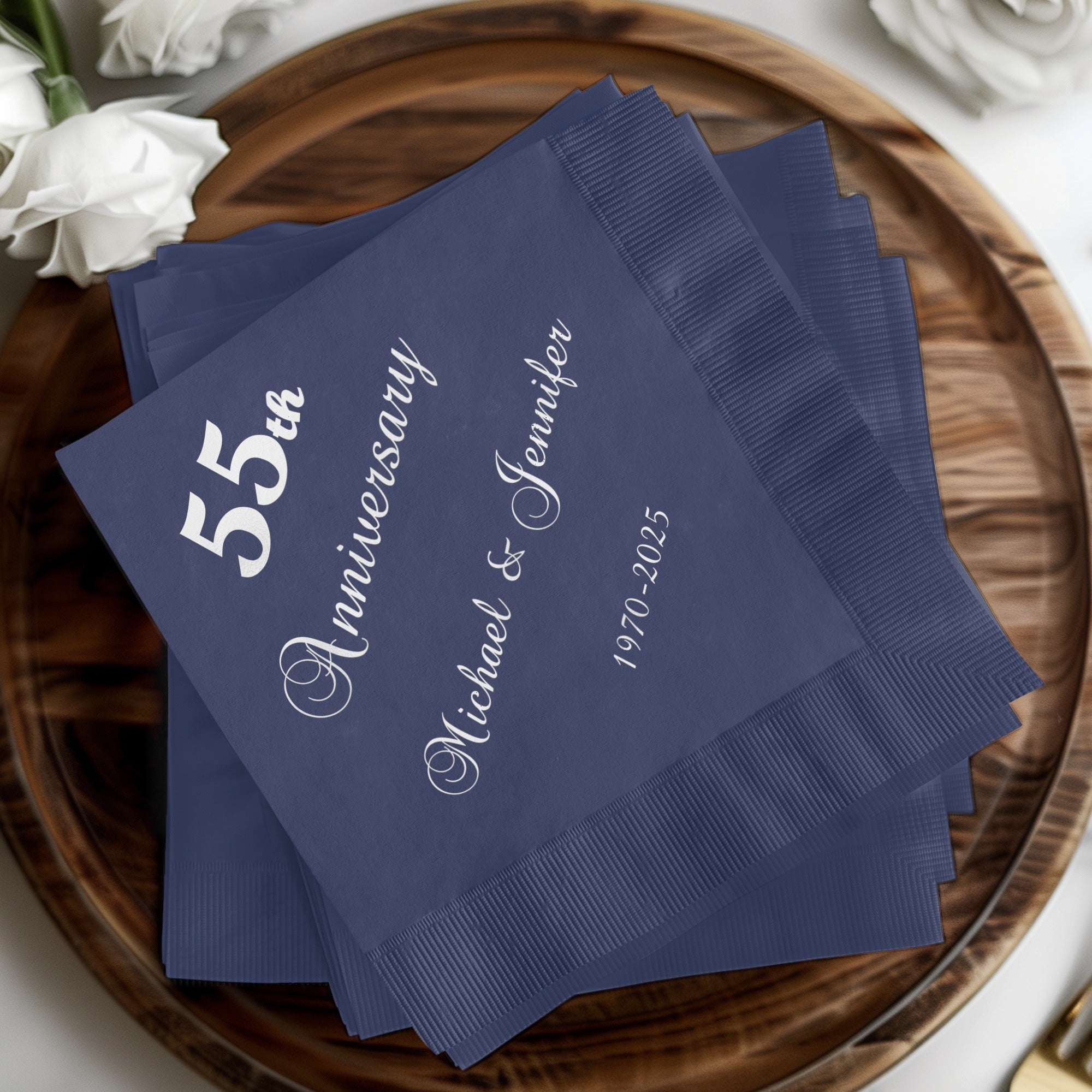 Navy blue napkins with "55th Anniversary Michael & Jennifer" text.