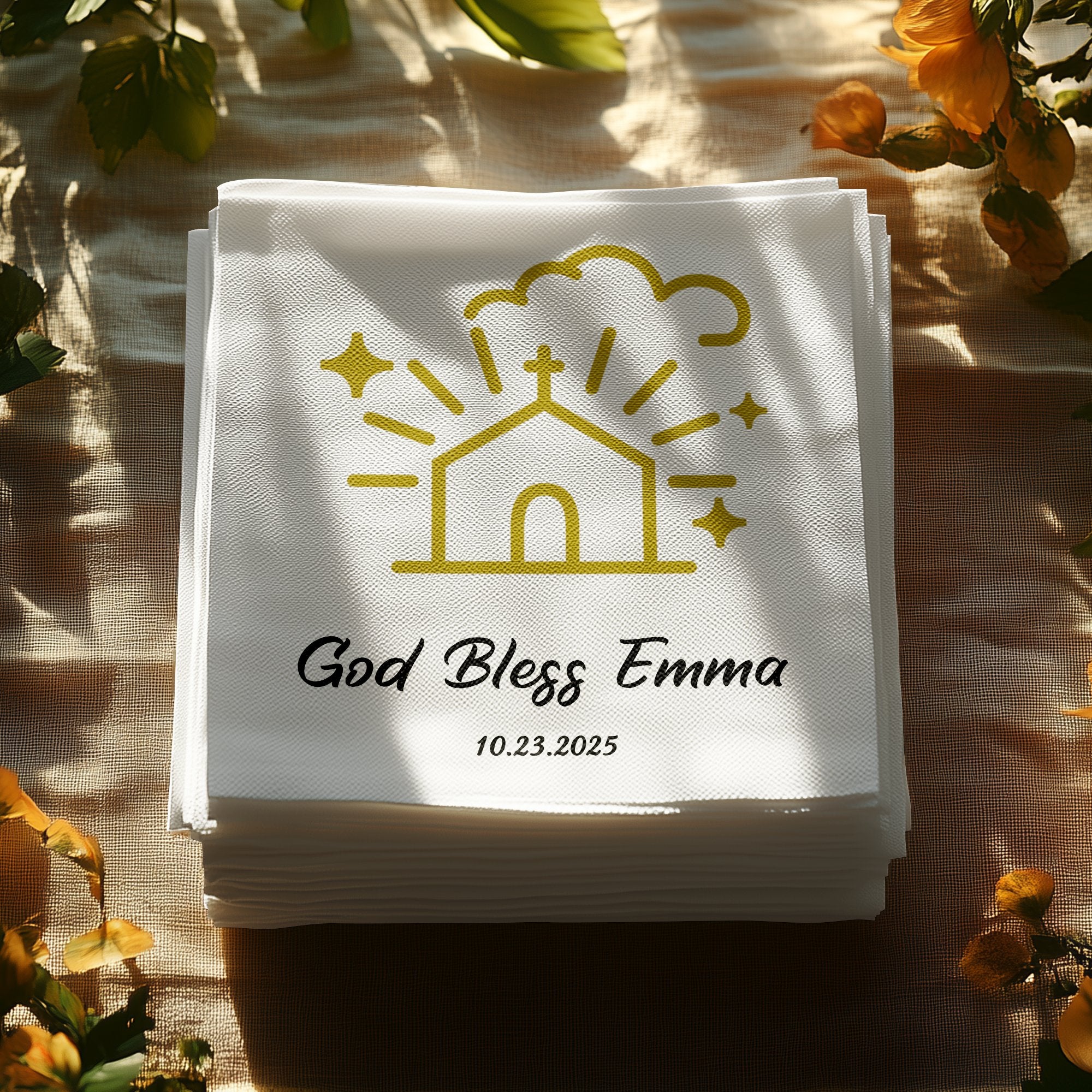 Stack of white napkins with "God Bless Emma 10.23.2025" and a church icon.