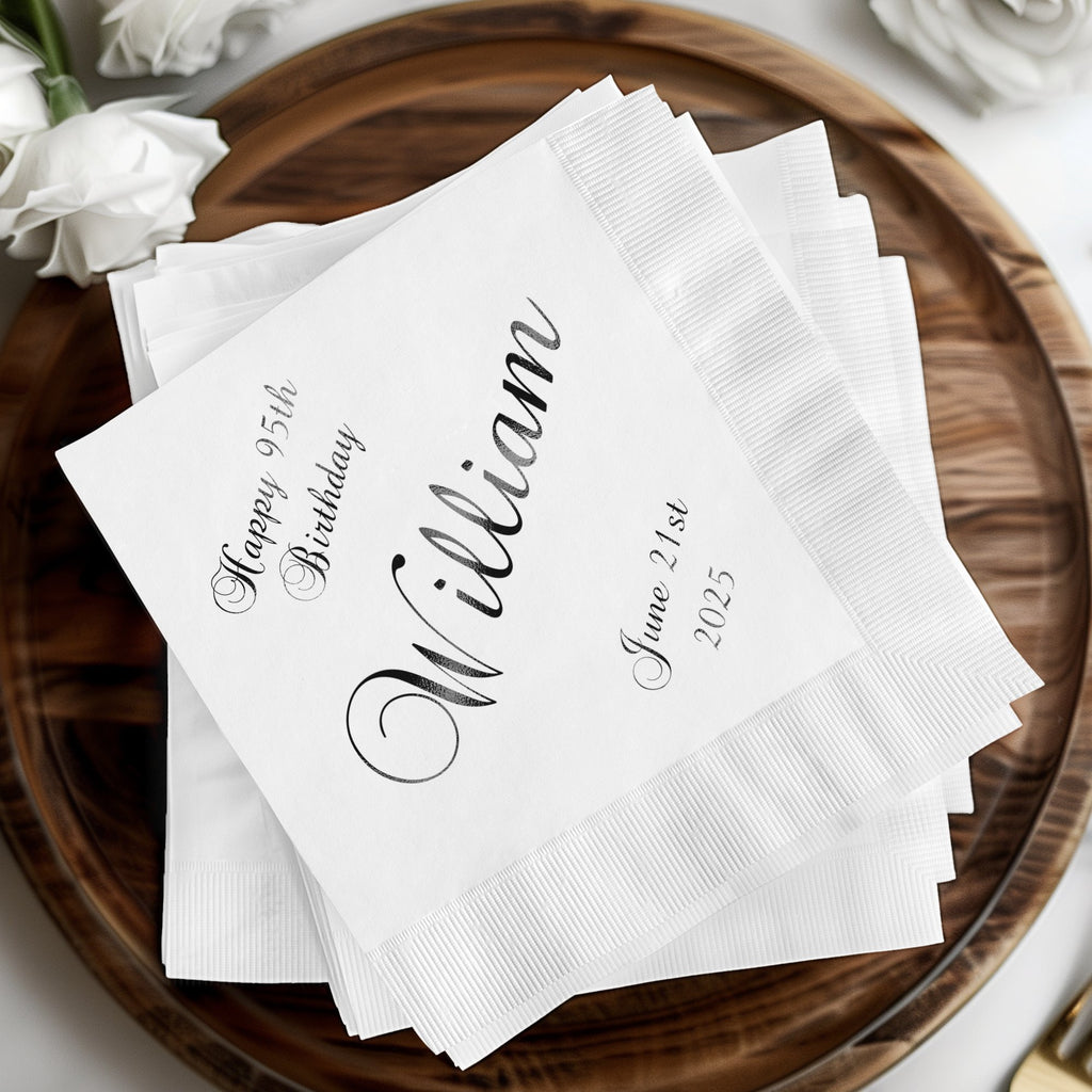 White cocktail napkins with "William" and "Happy 95th Birthday" in script.