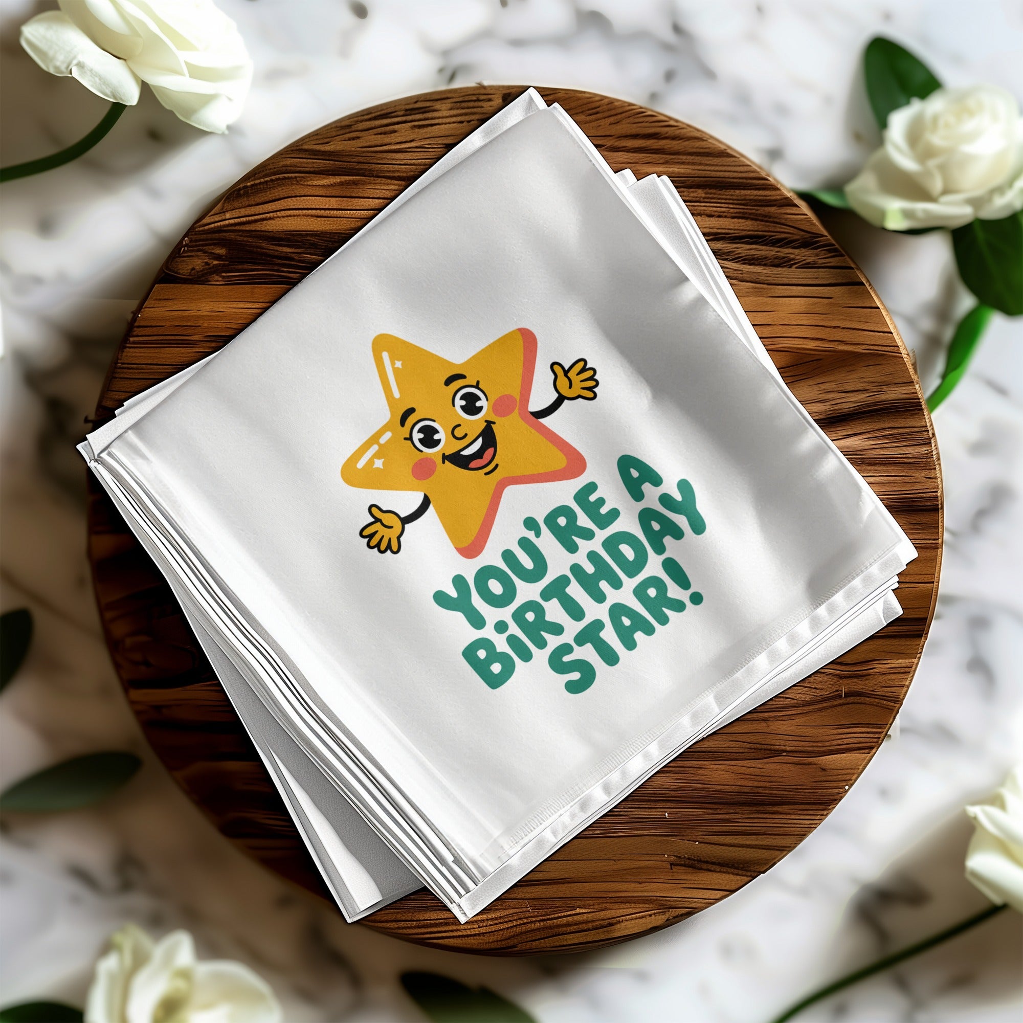 Folded white napkin with a cartoon star saying "You're a birthday star!".