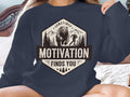 Navy sweatshirt with "Motivation Finds You" text and bear running graphic.